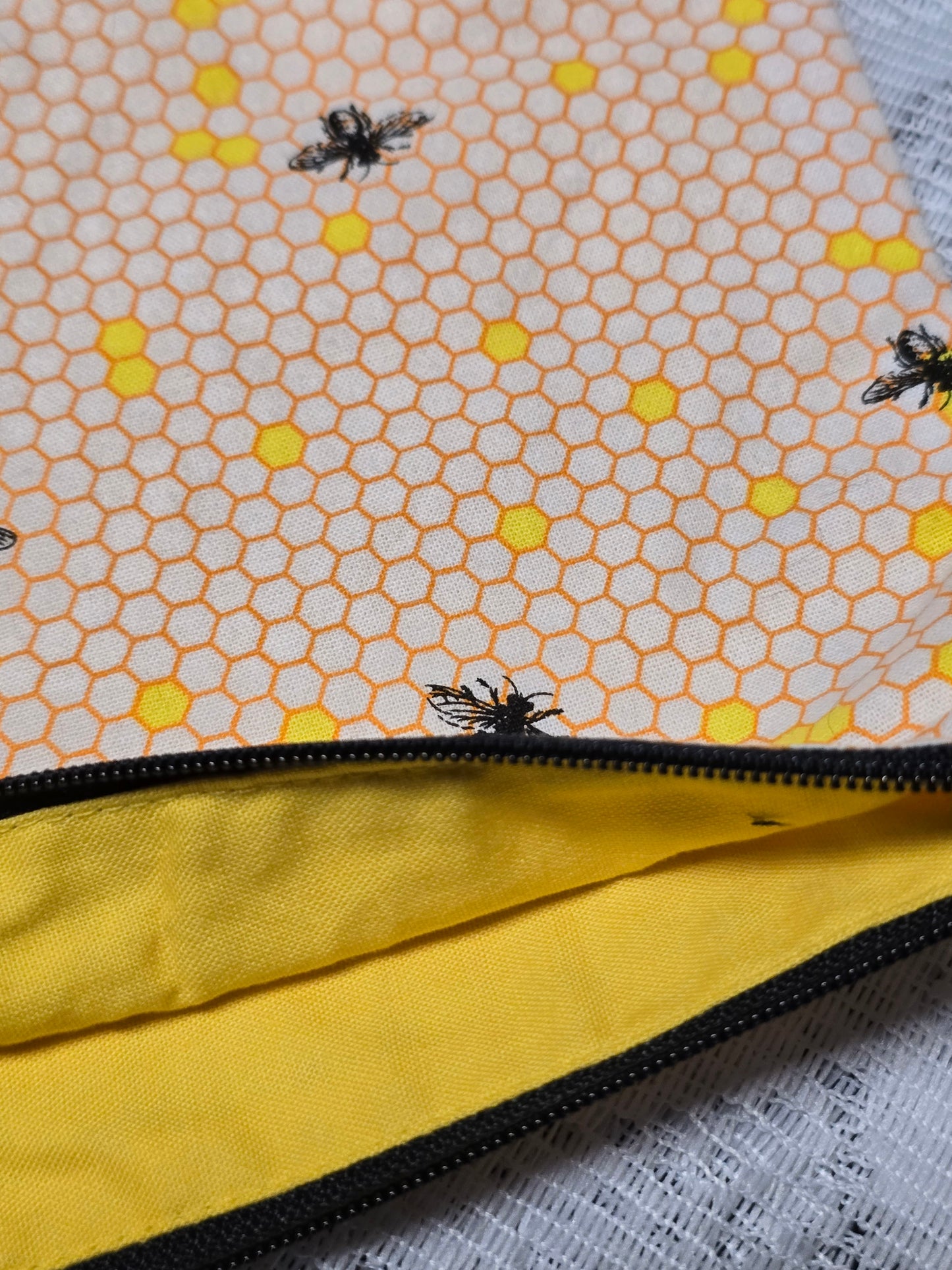 Yellow honeycomb with bees